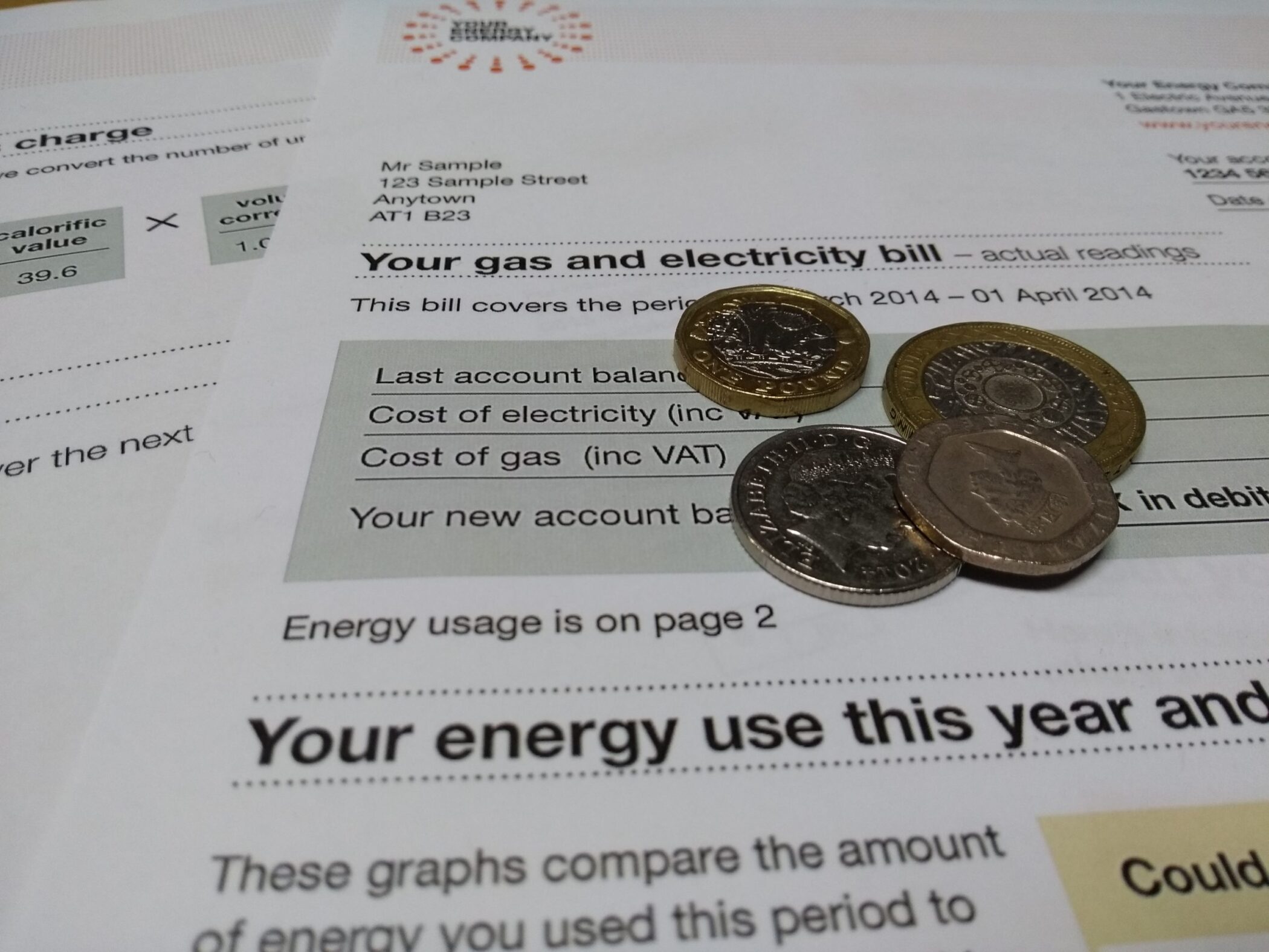 Coins on top of energy bill