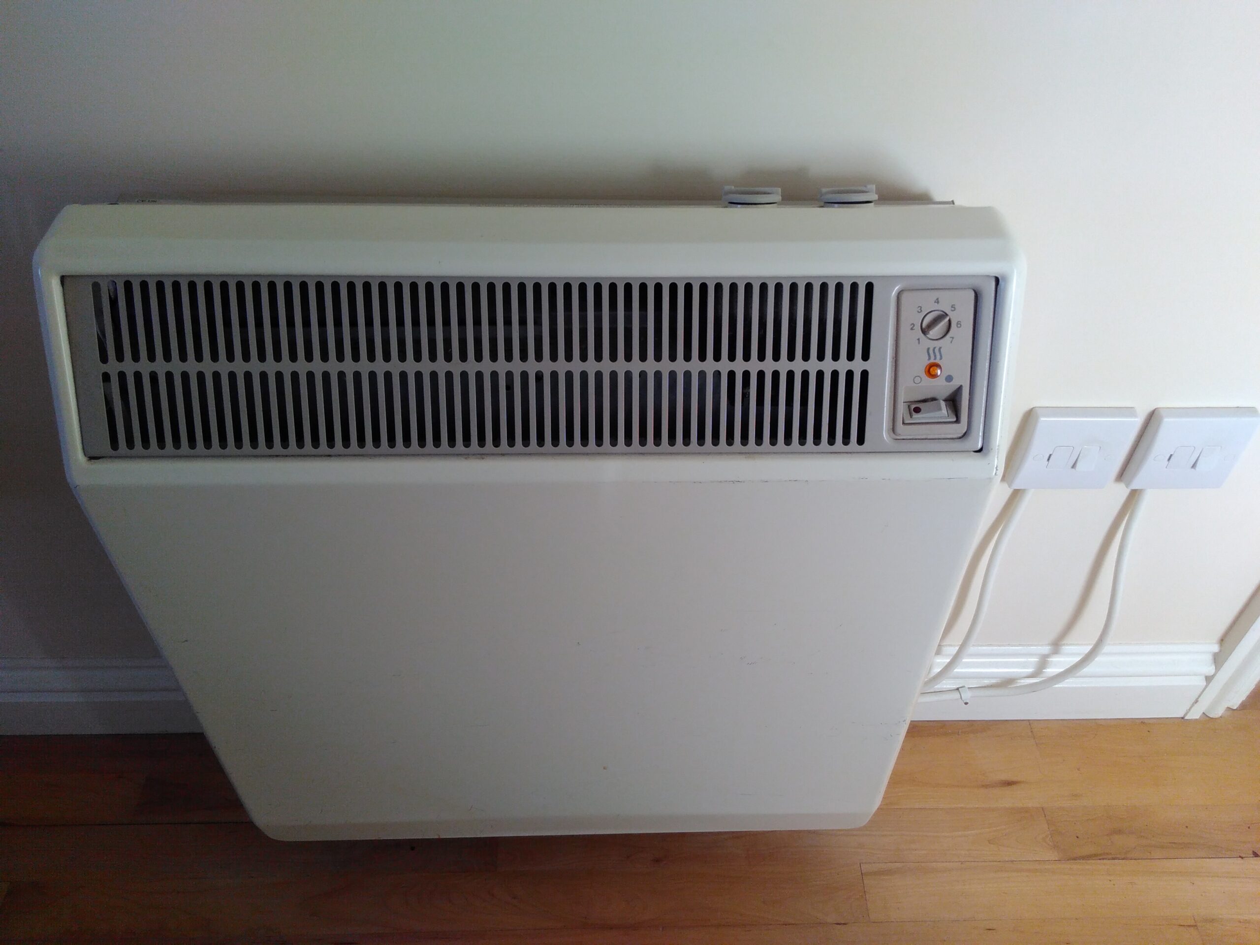 Storage heater with manual controls and two wall switches
